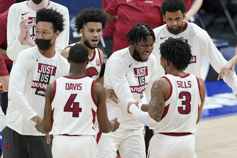 Arkansas players celebrate after defeating Missouri in an NCAA college basketball game in the Southeastern Conference Tournament Friday, March 12, 2021, in Nashville, Tenn. (AP Photo/Mark Humphrey)