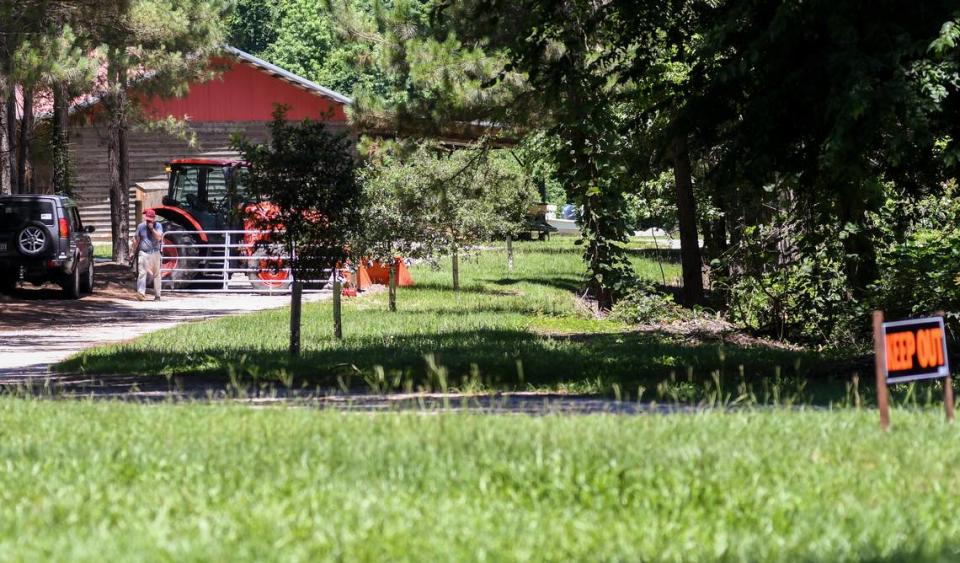 A “keep out” sign marks the driveway and a tractor blocks the entrance to the Murdaugh property on Thursday, June 17, 2021 as a man works to install gates at this entrance as well as the entrance to the main house on Moselle Road in Islandton, S.C. On Monday, June 7, 2021, Maggie Murdaugh, 52, and her son Paul Murdaugh, 22, died from gunshot wounds in an apparent homicide in at their residence in Colleton County.