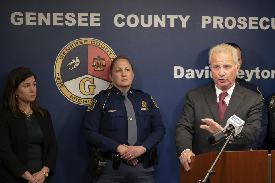 Genesee County Prosecutor David Leyton speaks, alongside Michigan State Police Lieutenant Kim Vetter, center, and Sen. Kristen McDonald Rivet, during a press conference to announce criminal charges filed against a Flint father, after his 2-year-old daughter accidentally shot herself, held in the 67th District Court in downtown Flint, Mich., on Tuesday, Feb. 20, 2024. Under Michigan's new "safe storage" laws, this is the first criminal complaint filed. (Julian Leshay Guadalupe/The Flint Journal via AP)