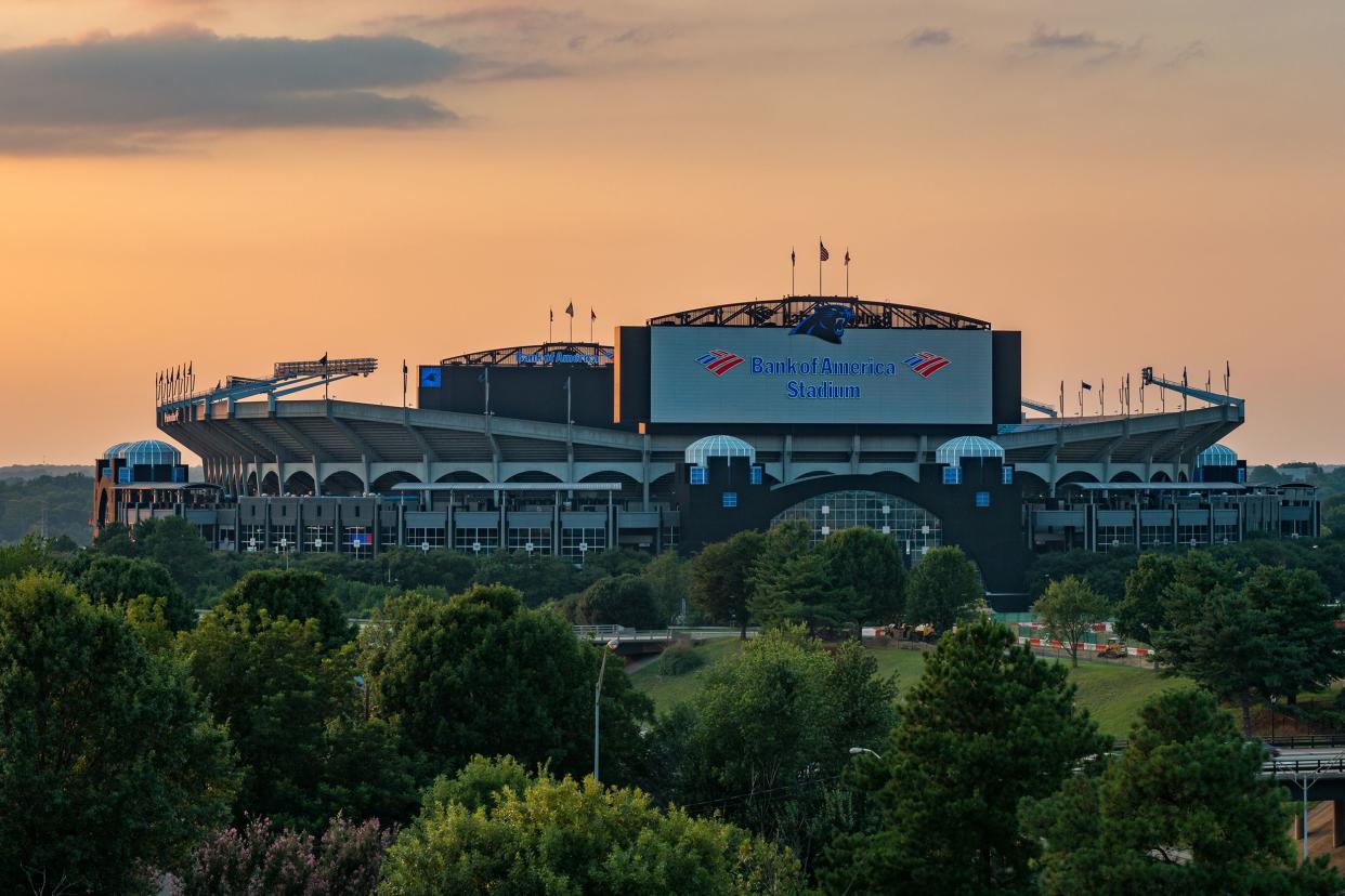Carolina Panthers, Bank of America Stadium, Charlotte, North Carolina, exterior with trees in the foreground and during sunset