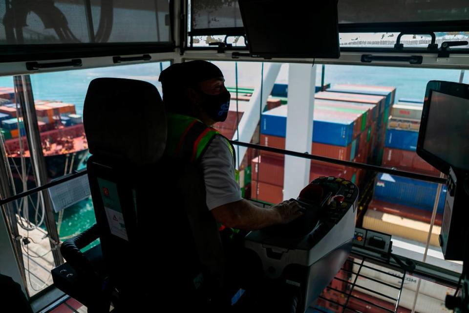 Longshoreman David Marks, a gantry operator, works to offload containers from a docked ship at PortMiami on Saturday, February 20, 2021. Marks has been working as a longshoreman for 19 years.