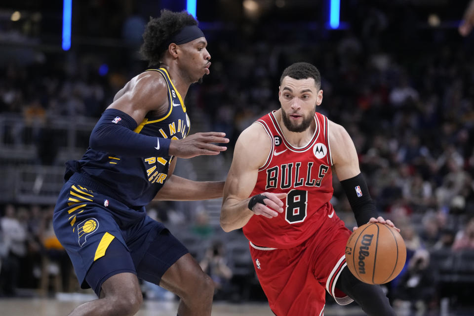 Chicago Bulls guard Zach LaVine (8) drives on Indiana Pacers guard Buddy Hield (24) during the second half of an NBA basketball game in Indianapolis, Tuesday, Jan. 24, 2023. The Pacers defeated the Bulls 116-110. (AP Photo/Michael Conroy)