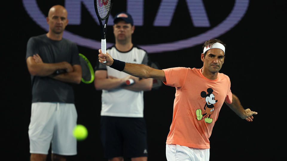 Roger Federer, pictured here practicing at the Australian Open as coaches Ivan Ljubicic and Severin Luthi look on.