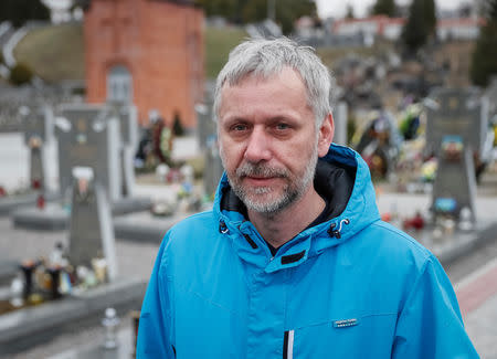 FILE PHOTO: Ihor Konchevych is seen near a grave of his brother at a Lychakiv cemetery in Lviv, Ukraine March 13, 2019. REUTERS/Gleb Garanich