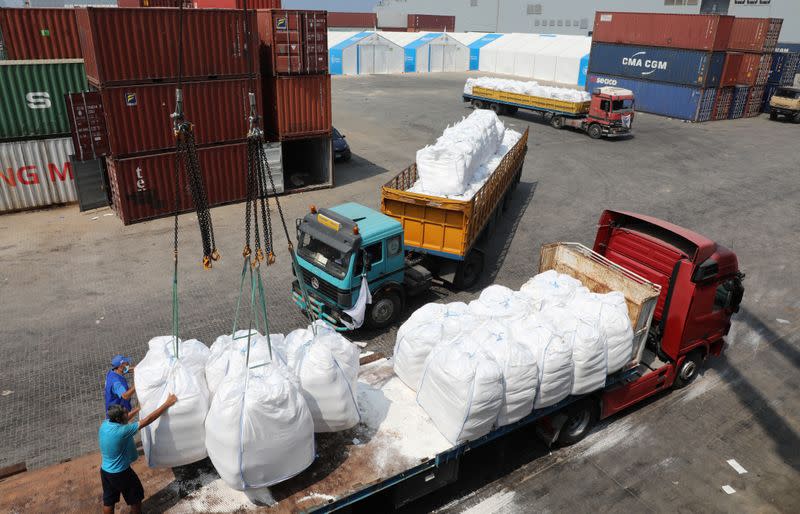 Humanitarian aid donated by World Food Program (WFP), are unloaded at Beirut's port