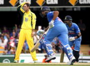 Australia's Glenn Maxwell (L) reacts after being hit for a boundary by Indian batsman Rohit Sharma (C), as he runs with team mate Virat Kohli between wickets, during their second One Day International cricket match in Brisbane January 15, 2016. REUTERS/Glenn Hunt/AAP