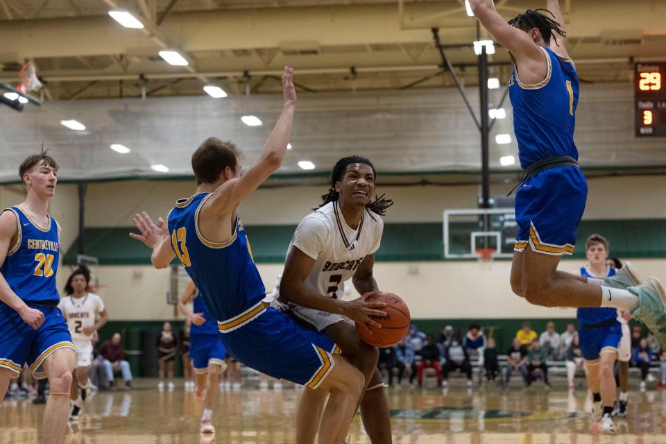 Brandywine's Jaremiah Palmer (3) drives down the lane as Centreville's Harrison Gregory (13) defends during the Brandywine-Centreville high school Division 3 regional championship basketball game on Wednesday, March 15, 2023, at Coloma High School in Coloma, Michigan.