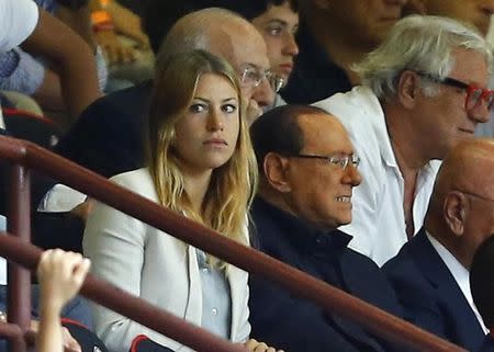 Former Italian Prime Minister Silvio Berlusconi sits in the tribune near his daughter Barbara during the Italian Serie A soccer match between AC Milan and Lazio at the San Siro stadium in Milan, August 31, 2014. REUTERS/ Stefano Rellandini