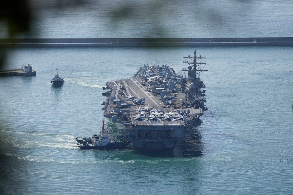 US aircraft carrier USS Ronald Reagan is escorted into Busan Naval Base in Busan, South Korea  (AP)
