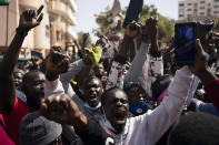 Demonstrators shout slogans during a protest against the arrest of opposition leader and former presidential candidate Ousmane Sonko near the Justice Palace of Dakar, Senegal, Monday, March 8, 2021. A Senegalese court cleared the way Monday for Sonko's release pending his rape trial in a case that already has sparked deadly protests and threatened to erode the country's reputation as one of West Africa's most stable democracies. (AP Photo/Leo Correa)