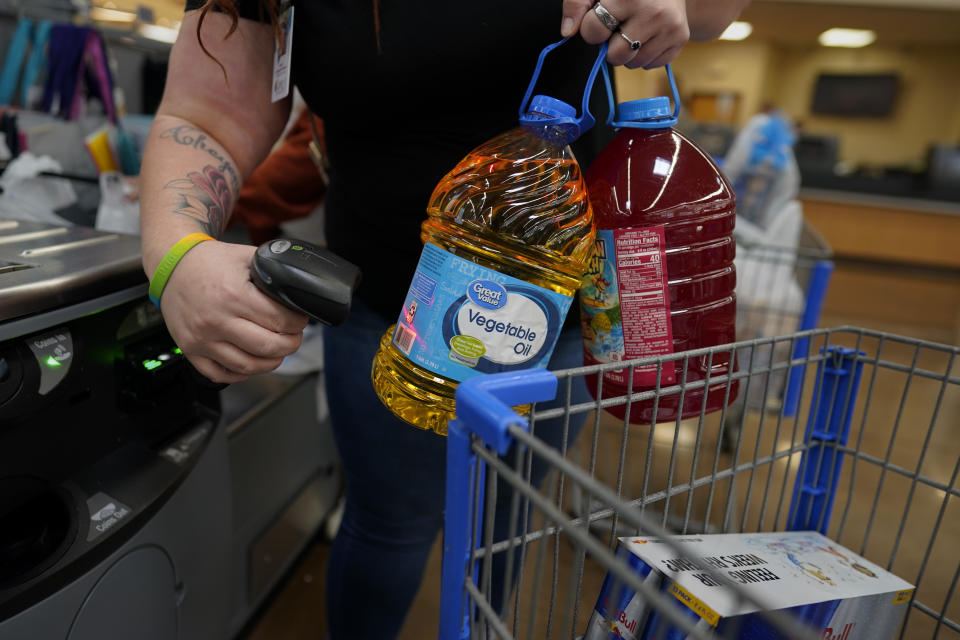 Jesse Johnson of the Family Resource Center helps her client Jodi Ferdinandsen check out at Walmart in Findlay, Ohio, Thursday, Oct. 12, 2023. Peer support services for people in recovery are a major component of Hancock County's strategy for addressing the opioid epidemic. (AP Photo/Carolyn Kaster)