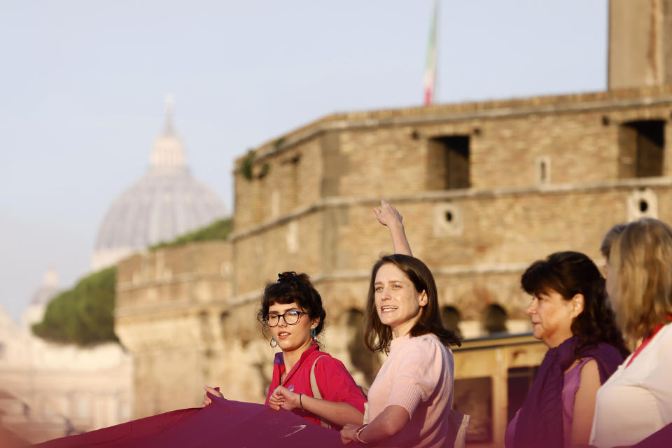 Executive director Kate McElwee, centre right, during a protest at St Angel Castle by WOC, Women Ordination Conference requesting the ordination of women to the priesthood, as Pope Francis begins a synod presiding over a mass in St. Peter’s Square at The Vatican, Wednesday, Oct. 4, 2023. Pope Francis has opened a big meeting on the future of the Catholic Church. (Cecilia Fabiano /LaPresse via AP)