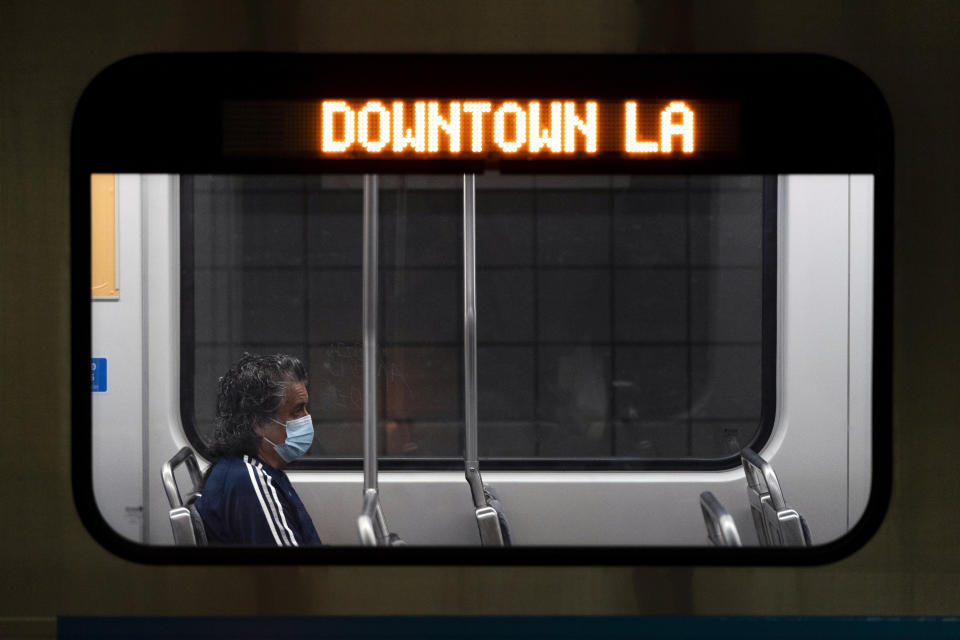 A commuter sits in a Los Angeles Metro train in Los Angeles, Wednesday, July 13, 2022. Los Angeles County, the nation's largest by population, is facing a return to a broad indoor mask mandate if current trends in hospital admissions continue, health director Barbara Ferrer told county supervisors Tuesday. (AP Photo/Jae C. Hong)