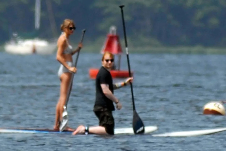 Taylor Swift and her musician pal Ed Sheeran go paddleboarding with their families near Taylor's home on Rhode Island. Taylor wore a two-piece striped bathing suit while Ed opted to keep his T-shirt, on while out on the water  Featuring: Taylor Swift,Ed S