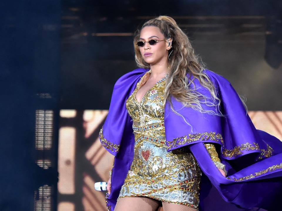 Beyonce performs in purple on stage during the 
