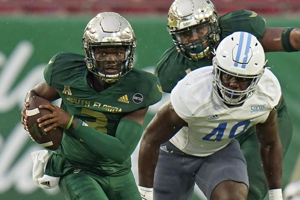 South Florida quarterback Jordan McCloud (3) breaks away from Citadel linebacker Marquise Blount (49) during the first half of an NCAA college football game Saturday, Sept. 12, 2020, in Tampa, Fla. (AP Photo/Chris O'Meara)