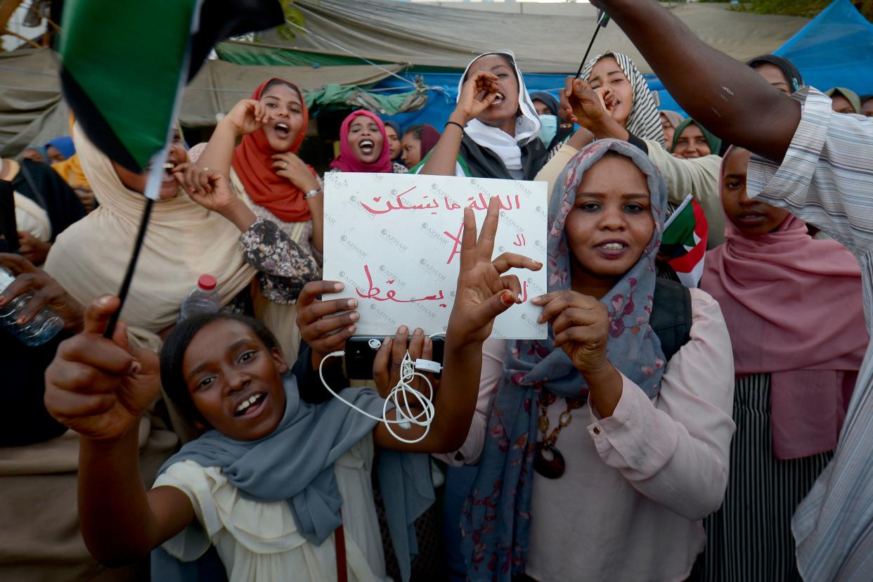 Sudanese demonstrators gather during a rally demanding a civilian body to lead the transition to democracy, in the Sudanese capital Khartoum on April 13, 2019. - Sudan's new military leader General Awad Ibn Ouf resigned late on April 12 just a day after being sworn in, as the country's army rulers insisted they would pave the way for a civilian government. (Photo by MOHAMMED HEMMEAIDA / AFP)        (Photo credit should read MOHAMMED HEMMEAIDA/AFP/Getty Images)