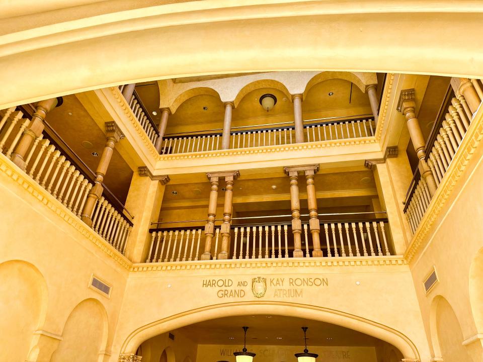 A large entryway with several balcony areas and railing with a sign saying Harold and Kay Ronson Grand Atrium