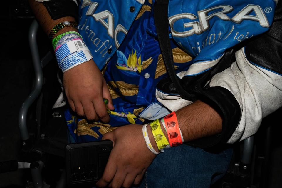 Hospital wristbands mix with colorful event wristbands on Saptarshi Majumdar's wrist.