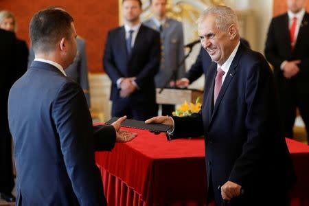 Czech President Milos Zeman hands over a document to Czech Interior Minister Jan Hamacek during the cabinet's inauguration at Prague Castle in Prague, Czech Republic June 27, 2018. REUTERS/David W Cerny