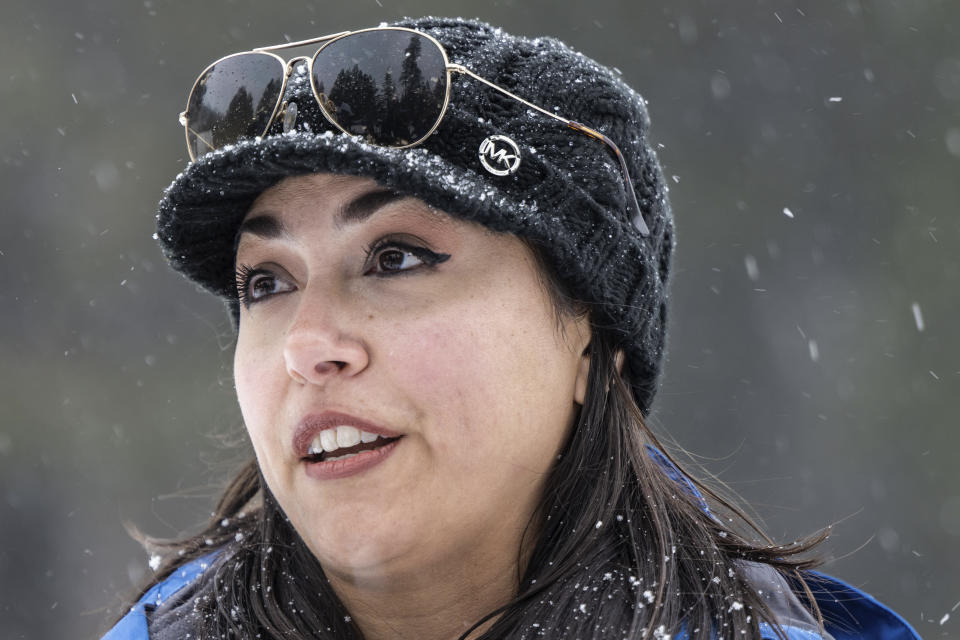 Snow falls as California Department of Water Resources hydrometeorologist Angelique Fabbiani-Leon warns against driving to the Sierra after she and her co-workers conducted a monthly snow survey at Phillips Station, Calif., on Thursday, Feb. 29, 2024. A Pacific storm packing powerful winds and heavy snow is shaping up to be the strongest of the season, forecasters say, as it pushes toward California with potential blizzard conditions in the Sierra and up to 10 feet (3 meters) of snow in the mountains around Lake Tahoe by the weekend. (Hector Amezcua/The Sacramento Bee via AP)