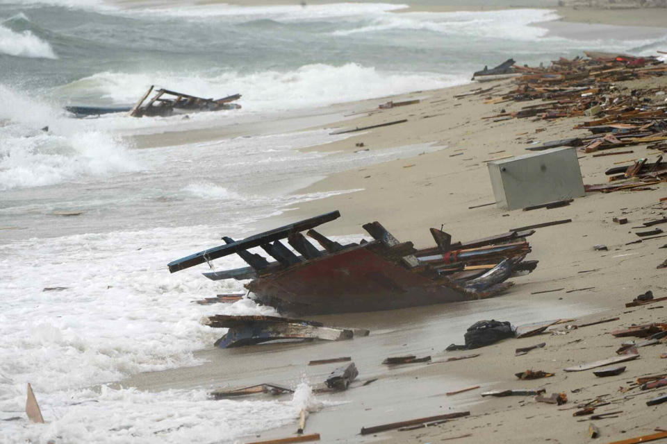 The wreckage from a capsized boat washes ashore at a beach near Cutro, southern Italy, Sunday, Feb. 26, 2023. Rescue officials say an undetermined number of migrants have died and dozens have been rescued after their boat broke apart off southern Italy. (Antonino Durso/LaPresse via AP)