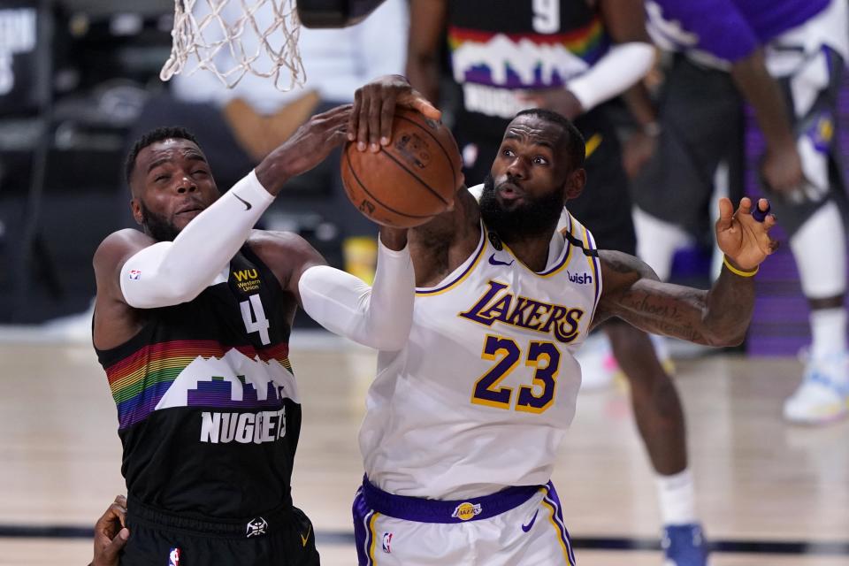 Denver Nuggets forward Paul Millsap (4) has his shot blocked by Los Angeles Lakers' LeBron James (23) during the second half of Game 3 of the NBA basketball Western Conference final Tuesday, Sept. 22, 2020, in Lake Buena Vista, Fla. (AP Photo/Mark J. Terrill)