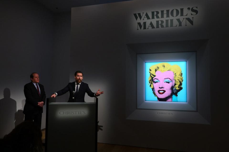 <div class="inline-image__caption"><p>Christie’s Americas chairman Marc Porter looks on as Alex Rotter announces that Christie's will offer Andy Warhol’s <em>Shot Sage Blue Marilyn.</em></p></div> <div class="inline-image__credit">Dia Dipasupil/Getty Images</div>