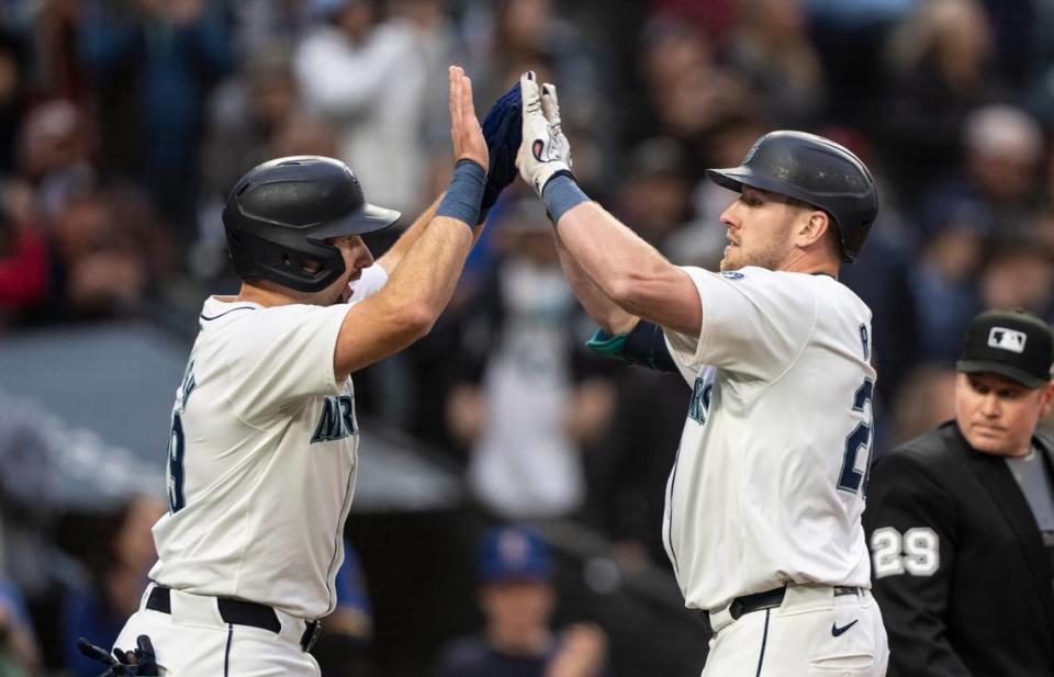 Mariners left fielder Luke Raley, right, is congratulated by catcher Cal Raleigh after hitting a two-run home run during the second inning of Monday night’s game against the Kansas City Royals at T-Mobile Park in Seattle.