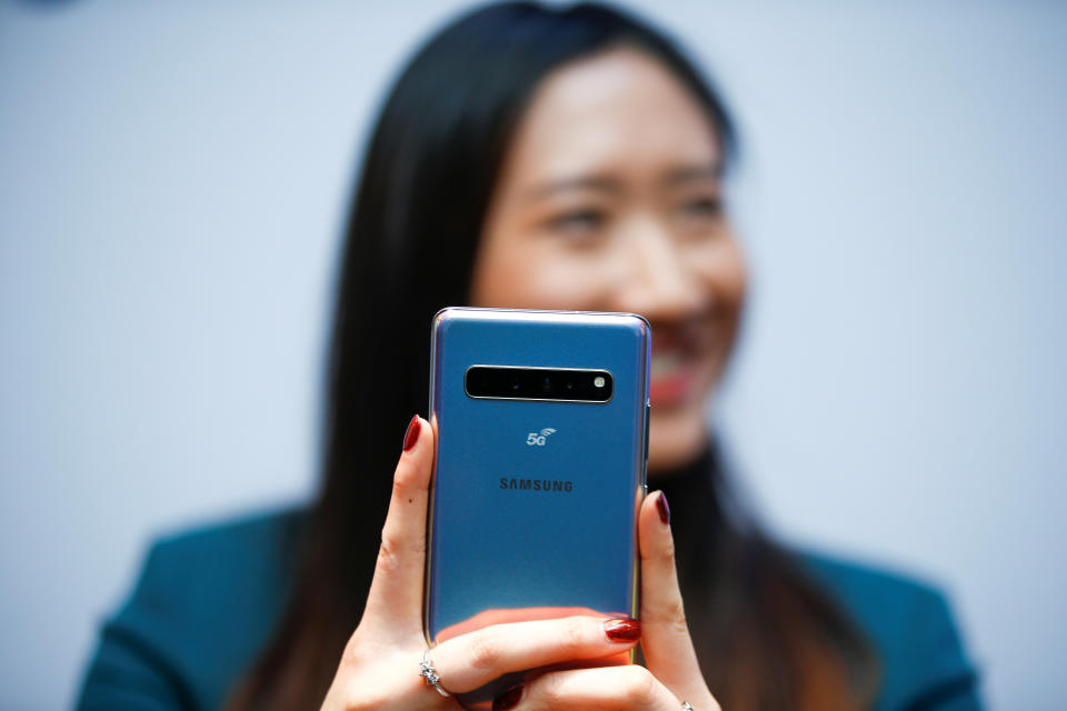 A Samsung employee poses with the new Samsung Galaxy S10 5G smartphone at a press event in London, Britain February 20, 2019. REUTERS/Henry Nicholls