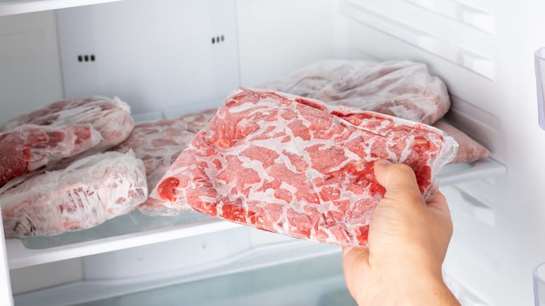 taking frozen meat out of freezer 