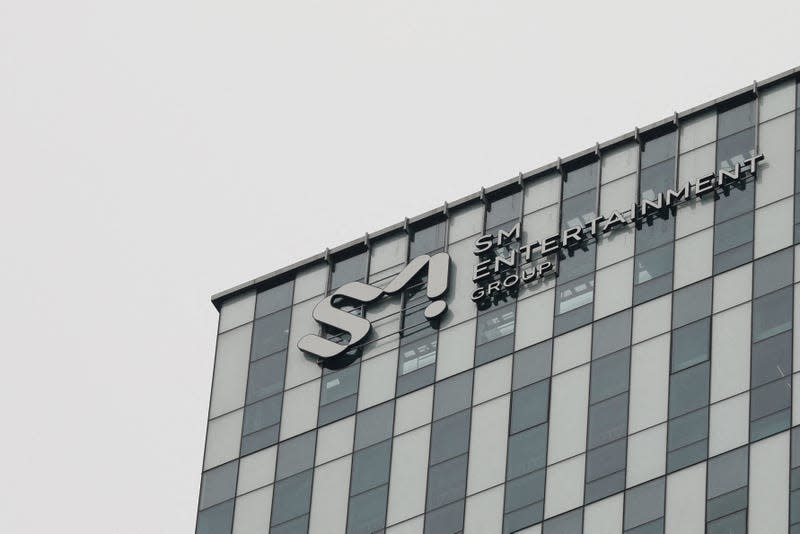 A view of the SM Entertainment Group building facade set against a gray sky.