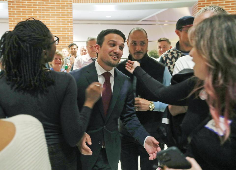 Shammas Malik is congratulated by his supporters as he makes his way to the stage at his mayoral watch party in the atrium of the John S. Knight Center in Akron on Tuesday.