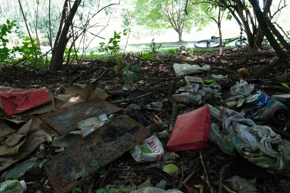 Rubbish is left in an abandoned homeless camp off the Shunga Trail on Aug. 8, 2023.