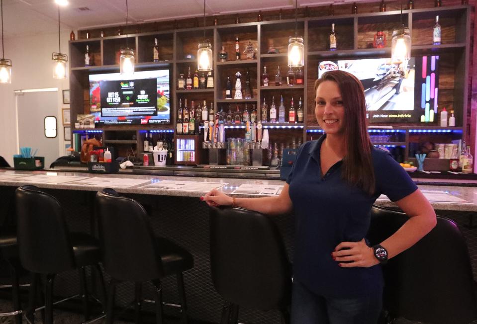 Michelle Smith, managing partner, stands at the bar inside Desposito's Seafood in Thunderbolt.