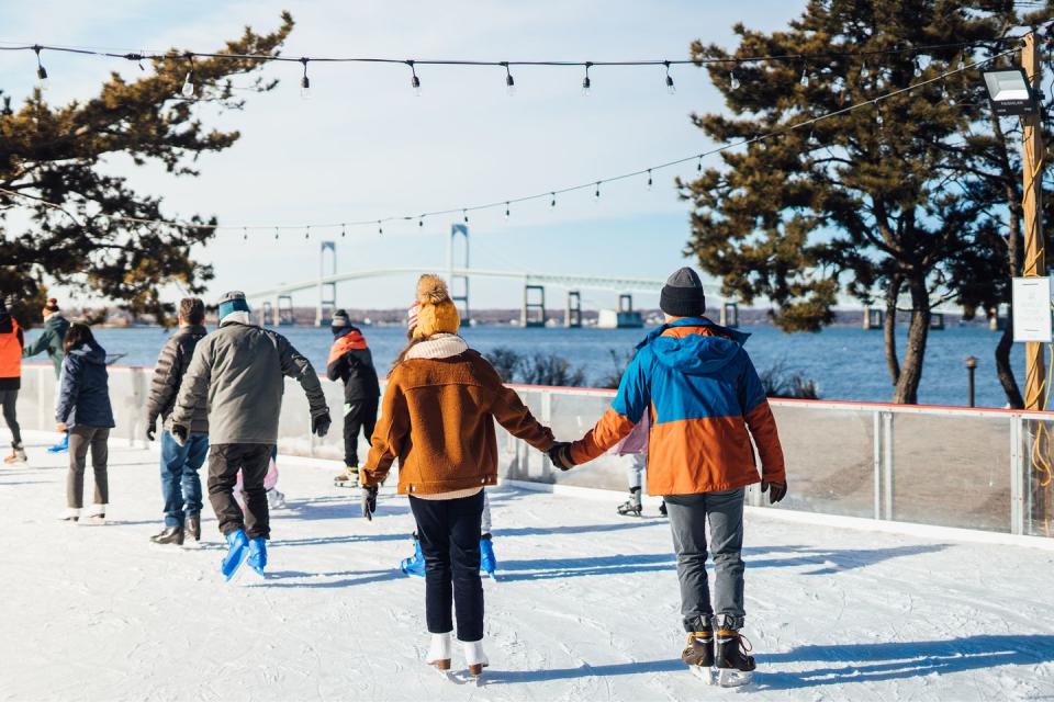 Go ice skating at a rink with a view of the Newport Bridge.