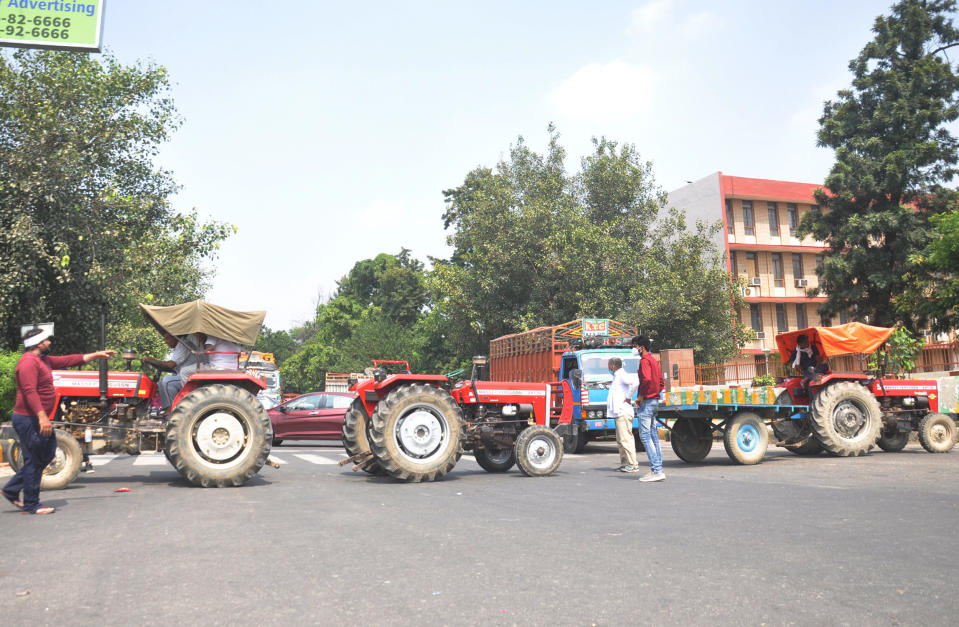 Bharatiya Kisan Union (BKU) members and Congress workers block the Ghaziabad-Hapur crossing with tractors to mark their protest against the agriculture reform bills passed by the Parliament, on September 25, 2020 in Ghaziabad, India. The two bills - the Farmers (Empowerment and Protection) Agreement on Price Assurance and Farm Services Bill, 2020 and the Farming Produce Trade and Commerce (Promotion and Facilitation) Bill, 2020 - were passed by the Rajya Sabha despite uproar and strong protest by the Opposition parties in the house. (Photo by Sakib Ali/Hindustan Times via Getty Images)