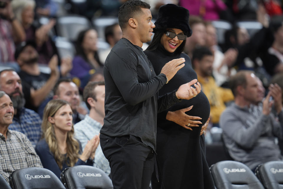 Denver Broncos quarterback Russell Wilson, center left, and his wife, center right, rap singer Ciara, look on as time runs out in an NBA basketball game between the Denver Nuggets and the New Orleans Pelicans, Monday, Nov. 6, 2023, in Denver. (AP Photo/David Zalubowski)