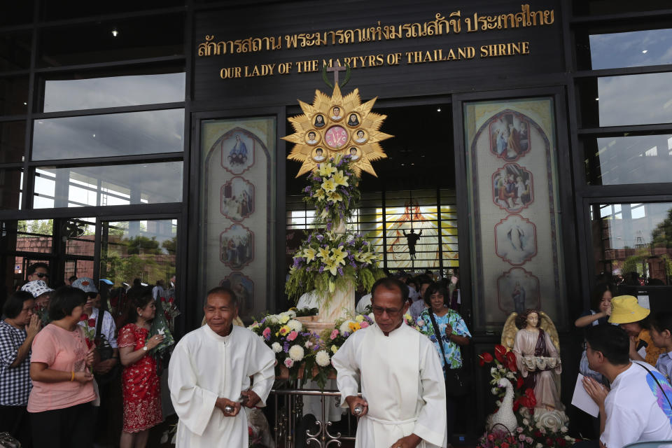 In this Saturday, Oct. 19, 2019, photo, Catholic devotees pulling a pedestal with images of the seven martyrs at Christ Church, Songkhon village, Mukdahan province, northeastern of Thailand. In 1940, seven villagers here were executed for refusing to abandon their Catholic faith, which Thai nationalists had equated with loyalty to France, whose colonial army in neighboring Indochina had fought Thailand in a brief border war. The seven were beatified in 1989 by Pope John Paul II, the first step to being named a saint. (AP Photo/Sakchai Lalit)