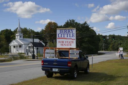 A pick up truck is covered with signs for New Hampshire State Senate candidate Jerry Little in Bradford, New Hampshire September 8, 2014, one day before the state's primary election. REUTERS/Brian Snyder