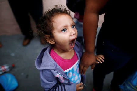 A girl, a member of a migrants caravan from Central America, yawns at the end of the caravan journey through Mexico, prior to preparations for an asylum request in the U.S., in Tijuana, Baja California state, Mexico April 26, 2018. REUTERS/Edgard Garrido