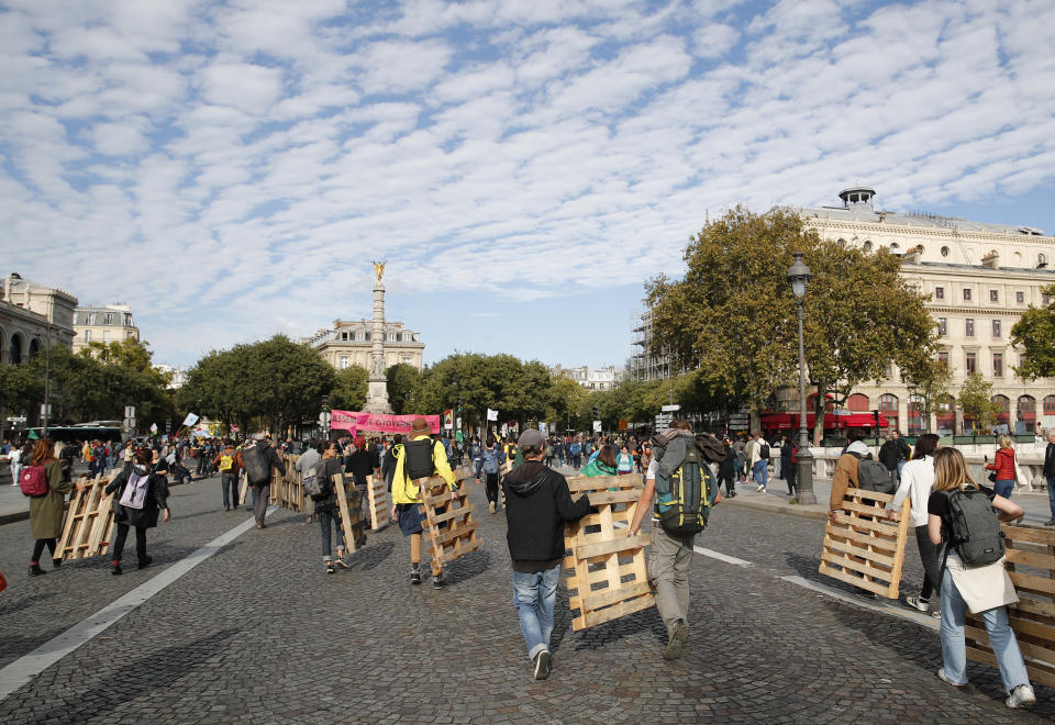 Activists from Extinction Rebellion block a bridge leading to a square Monday, Oct. 7, 2019 in Paris. Hundreds of activists with the Extinction Rebellion climate protest movement are blocking a central square in Paris. Monday's action by the group also known as XR comes as part of a series of protests in cities around Europe to demand urgent action against climate change. (AP Photo/Francois Mori)