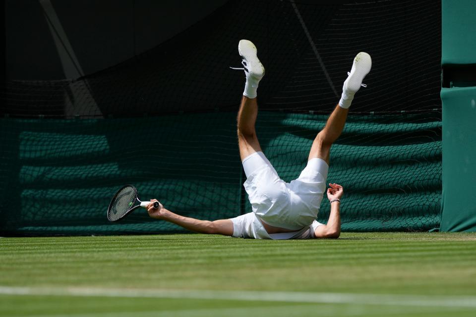Germany's Alexander Zverev falls over during the men's singles match against Gijs Brouwer of the Netherlands on day four of the Wimbledon tennis championships in London, Thursday, July 6, 2023.