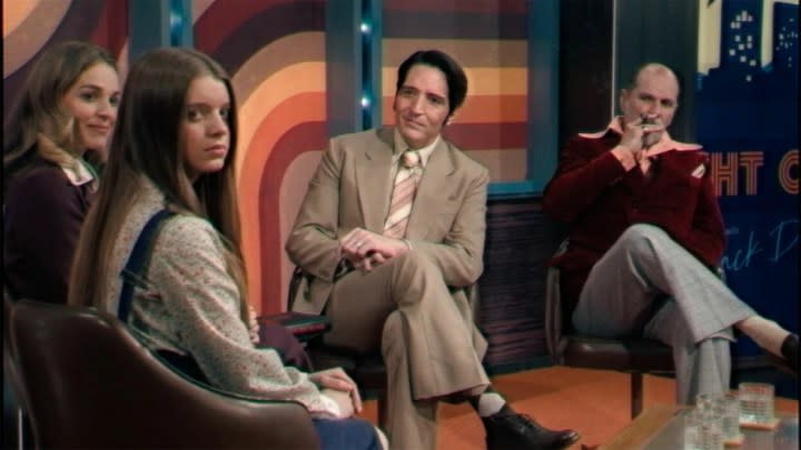 Four people sit on a stage in Late Night with the Devil.