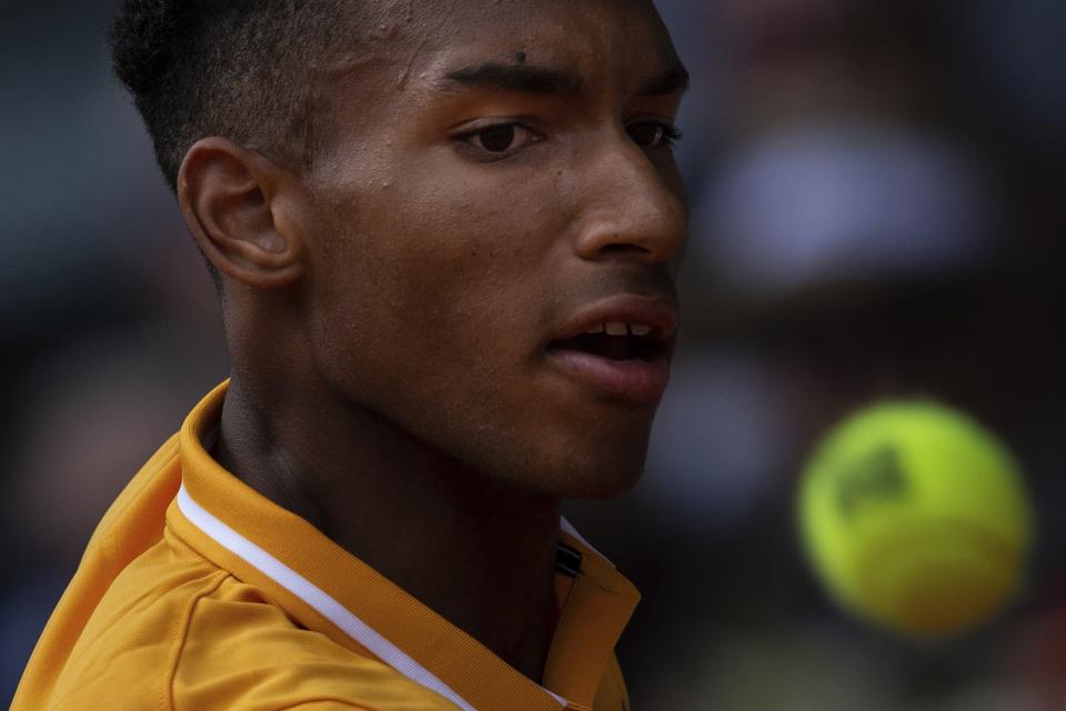 Felix Auger-Aliassime, from Canada, looks at the ball during the Madrid Open tennis match against Rafael Nadal, from Spain, in Madrid, Wednesday, May 8, 2019. (AP Photo/Bernat Armangue)