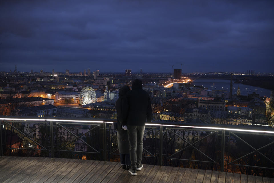 A couple embrace at a viewpoint overlooking Kyiv, Ukraine, Saturday, Nov. 18, 2023. (AP Photo/Felipe Dana)