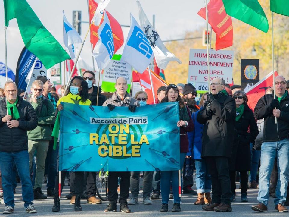 People marched through the streets of Montreal to call on the provincial and federal governments to step up their plans to address the climate crisis. (The Canadian Press - image credit)