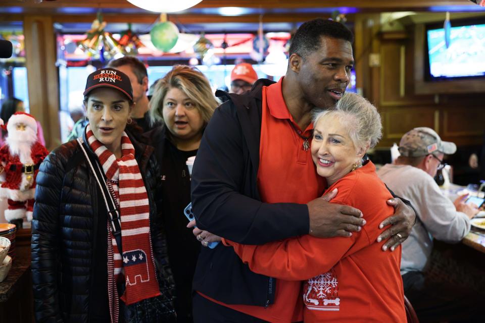 Georgia Republican Senate nominee Herschel Walker campaigns at a diner on Dec. 6, 2022, in Marietta.