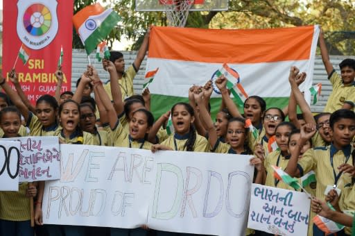 Indian students celebrate after the destruction of a low-orbiting satellite in a test of a new missile