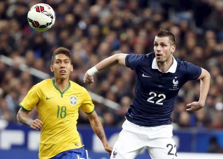 France's Morgan Schneiderlin (R) fights for the ball with Brazil's Firmino during their international friendly soccer match at the Stade de France, in Saint-Denis, near Paris, March 26, 2015. REUTERS/Charles Platiau